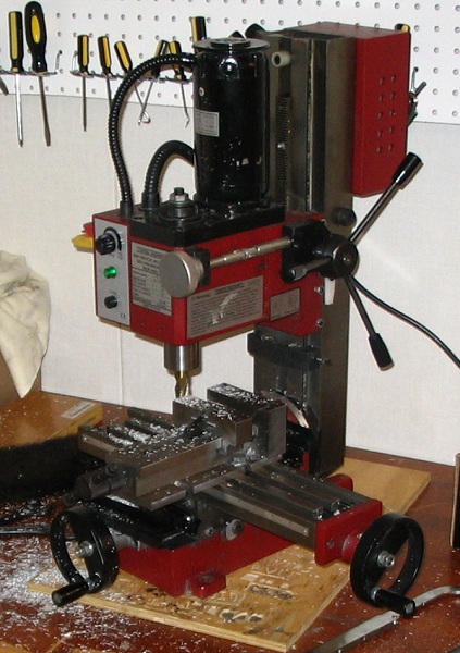  A miniature hobbyist mill plainly showing the basic parts of a mill. 